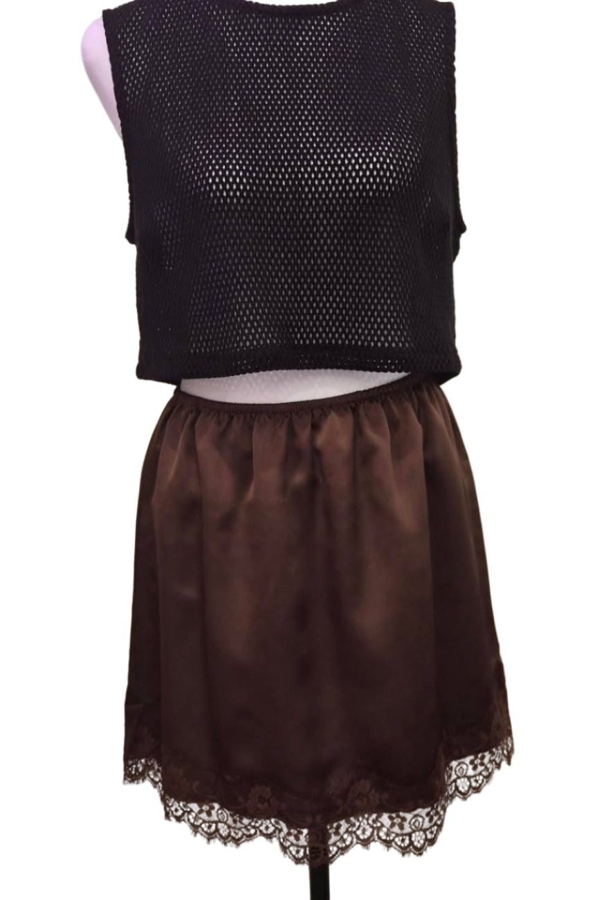 Black sleeveless top and brown skirt on a mannequin against a plain background